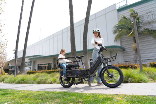 cargo ebike with children and women on the grass